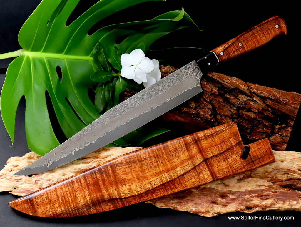270mm long hand-forged damascus carving knife with curly Hawaiian koa wood handle matching storage sheath by SalterFineCutlery