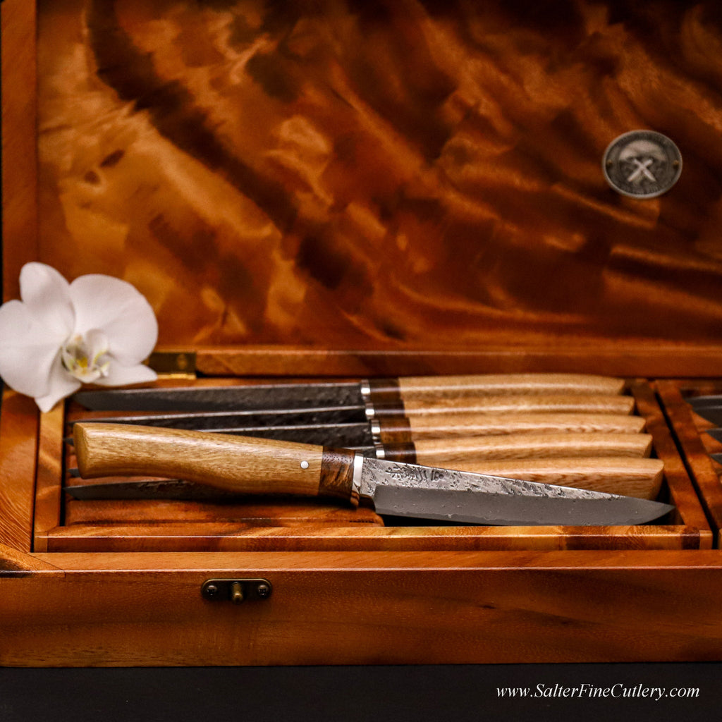 Set of twelve steak knives in a box with detail of one knife with two-toned wood freeform handle by SalterFineCutlery