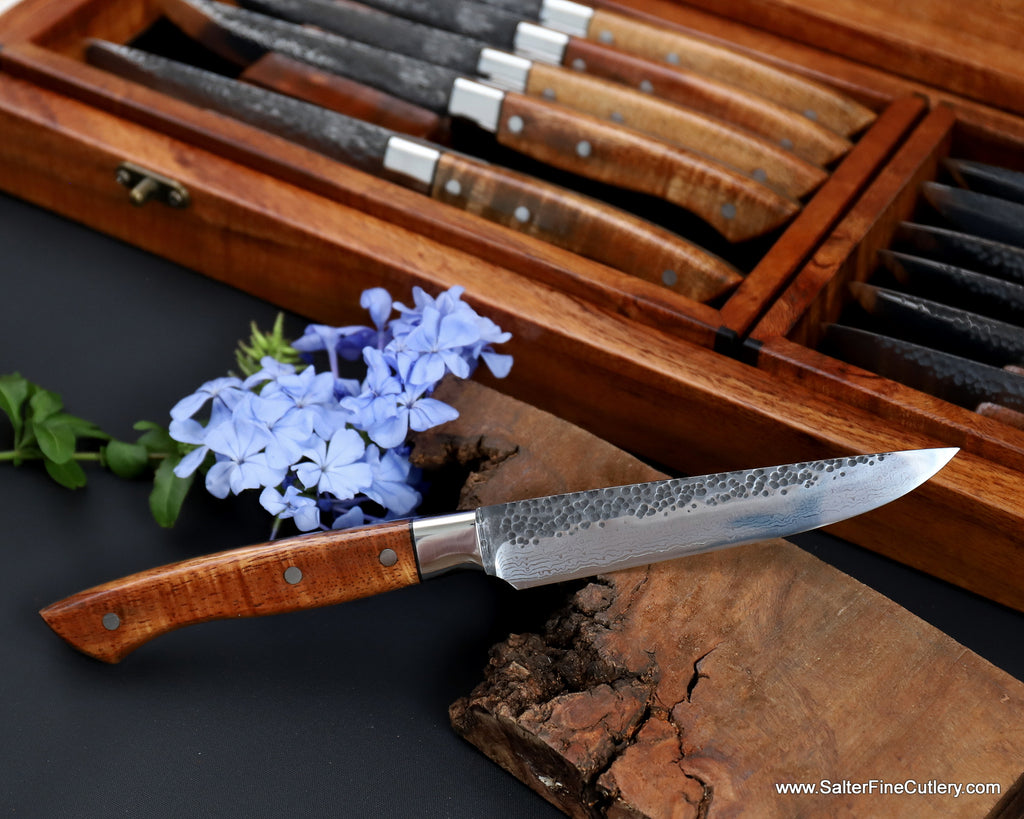 Custom hand-forged steak knife set with hammered damascus pattern and curly Hawaiian koa wood handles from SalterFineCutlery Hawaii