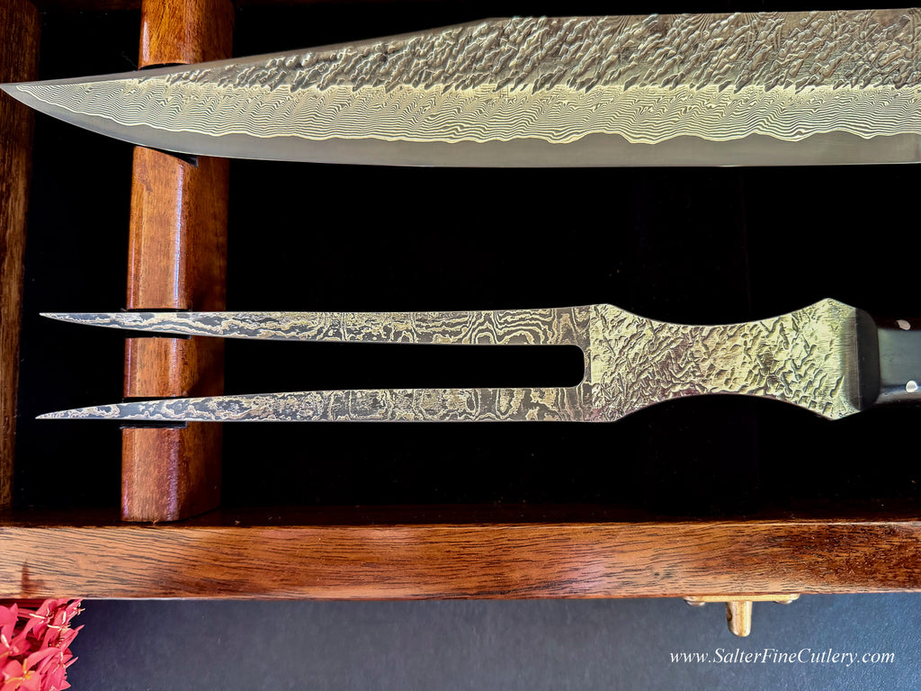 Close up view of a new carving knife set showing pattern on this hand-forged knife and fork