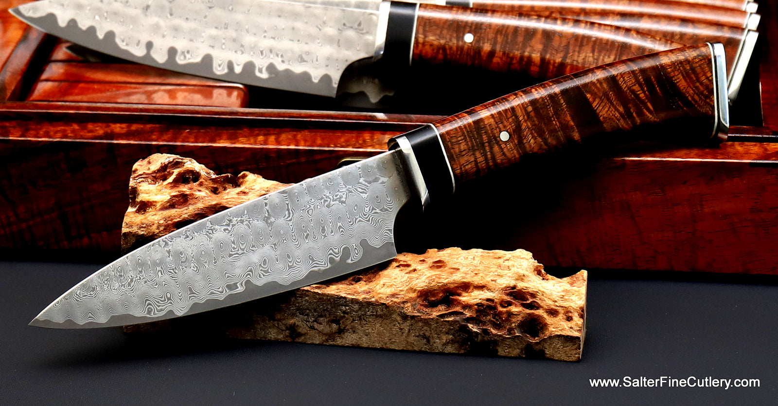 Luxury handmade steak knife with rare Hawaiian wood handles box with additional knives in background SalterFineCutlery