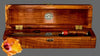 An open handmade presentation box to hold a collectible chef knife with a mirror-polish finish matching curly koa wood handle and box handcrafted by SalterFineCutlery