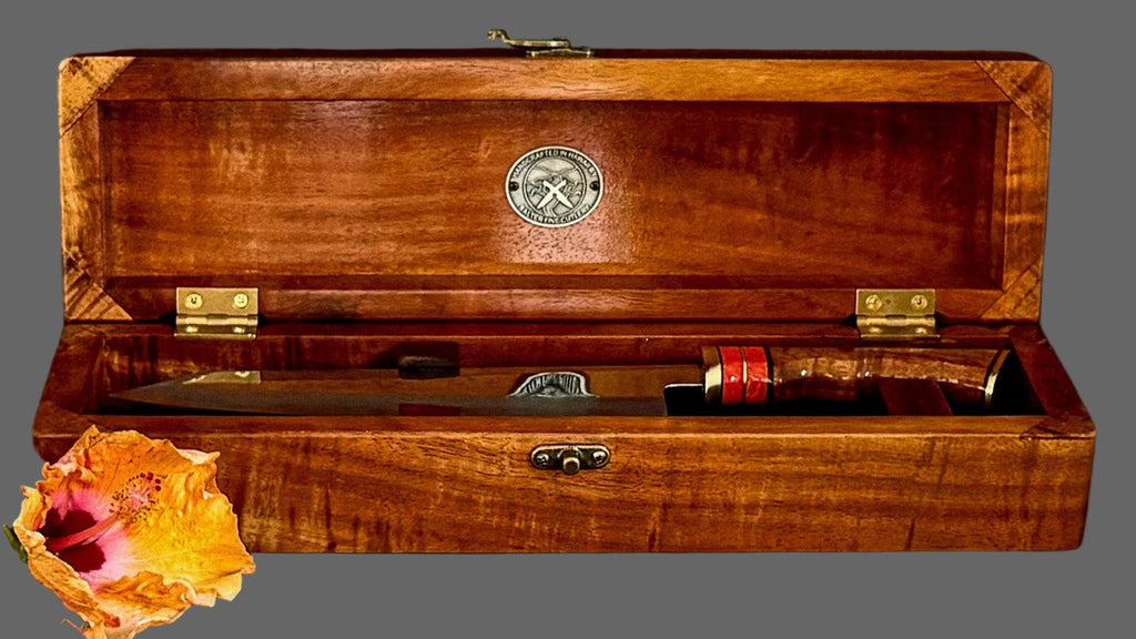 An open handmade presentation box to hold a collectible chef knife with a mirror-polish finish matching curly koa wood handle and box handcrafted by SalterFineCutlery
