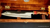 Collectible shirogami hand-forged chef knife from Osaka Japan with mirror polish finish and artist-series handle shown inside open presentation box handcrafted by SalterFineCutlery Hawaii