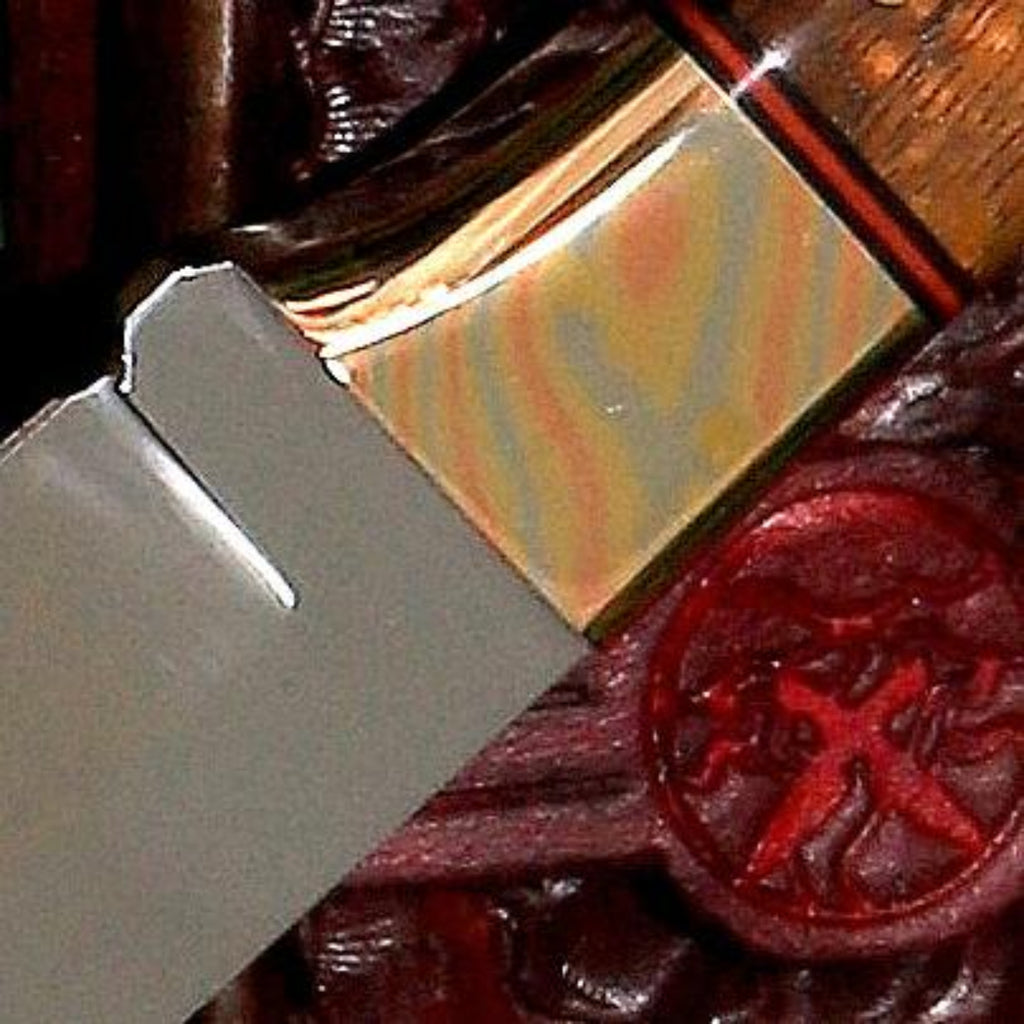 Collectible fixed blade knife handcrafted from SalterFineCutlery Mokume contoured bolster detail