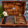 A handcrafted 8-piece steak knife set with hand-forged Japanese blades with Hawaiian rare old-growth curly koa wood handles and matching presentation box luxury quality handcrafted in Hawaii by SalterFineCutlery