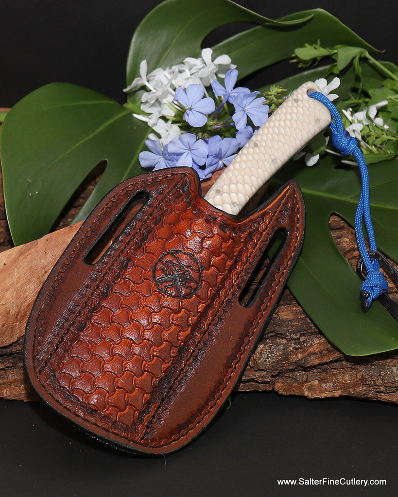 Hunting knife with white snake pattern handle and blue liners and trim in handcrafted handtooled leather belt sheath from SalterFineCutlery in Hawaii