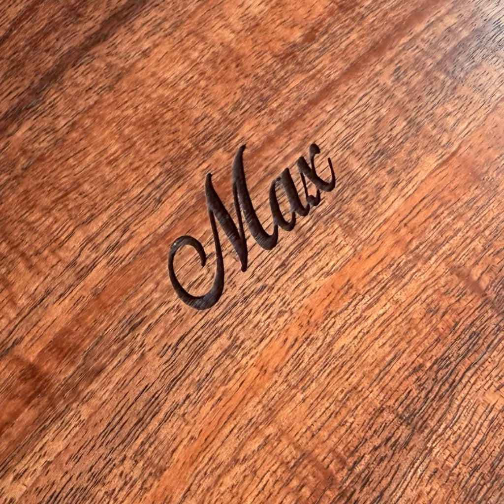 Detail view of personalized lid engraving on mens curly koa wood valet or jewelry box handcrafted by SalterFineCutlery and custom woodworking in Hawaii
