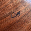 Detail view of personalized engraving on the top of a mens curly koa wood valet box handcrafted in Hawaii by SalterFineCutlery