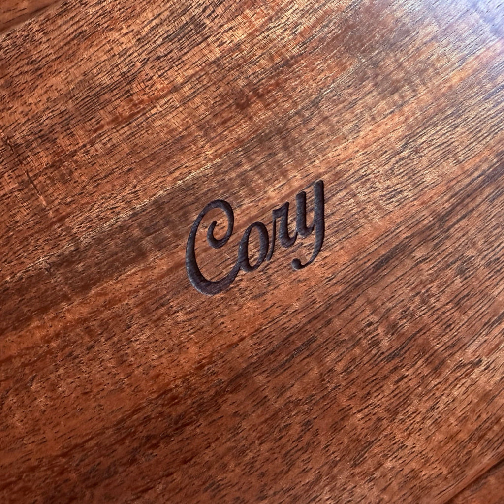 Detail view of personalized engraving on the top of a mens curly koa wood valet box handcrafted in Hawaii by SalterFineCutlery