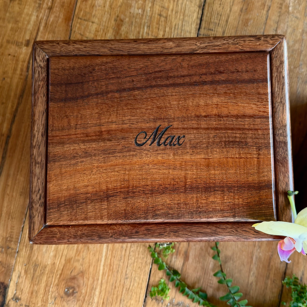 Detail view of custom personized engraving available on a jewelry or valet box handcrafted of Hawaiian curly koa wood by SalterFineCutlery