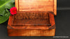 Memento or small jewelry box with lift-off lid shown behind bottom of box detail handcrafted curly Hawaiian koa wood handcrafted by SalterFineCutlery and custom woodworking 