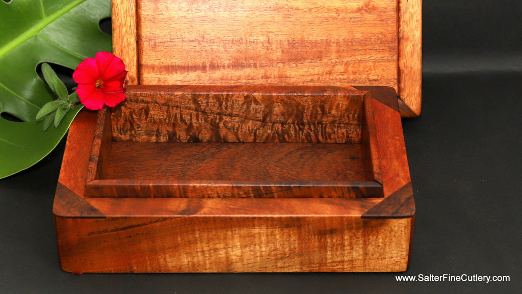 Memento or small jewelry box with lift-off lid shown behind bottom of box detail handcrafted curly Hawaiian koa wood handcrafted by SalterFineCutlery and custom woodworking 