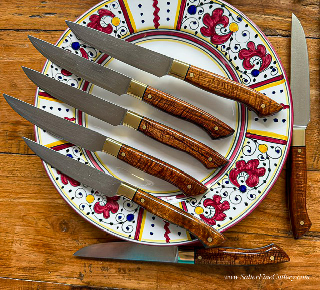7 sample steak knives shown with dinner plate to illustrate refurbished steak knives after many years of use in a busy NYC restaurant SalterFineCutlery services what we sell
