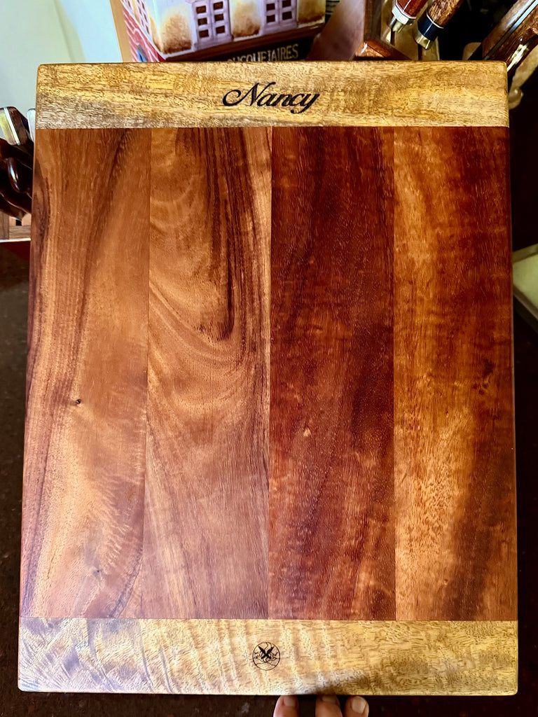 A personalized serving or cutting board handcrafted in Hawaii of koa and mango woods by SalterFineCutlery and custom woodworking