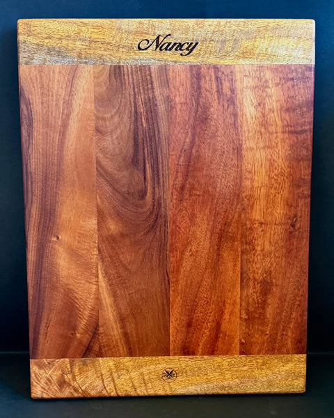 Rectangular serving board made from Hawaiian curly koa wood with mango emd pieces. Custom engraving added.  Handcrafted by SalterFineCutlery and custom woodworking